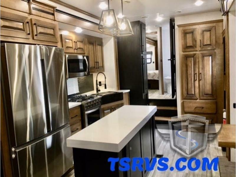 Kitchen with a gas burner, fridge, oven, sink and cabinets.