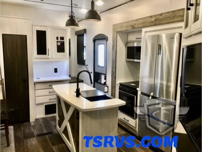 Kitchen with a gas burner, fridge, oven, sink and cabinets.