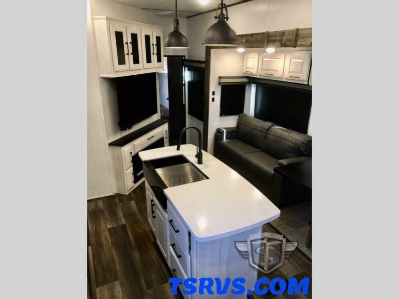 Interior view of the RV with a kitchen sink and a living space.