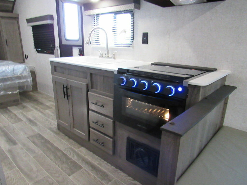 Kitchen with a gas burner, sink and cabinets.