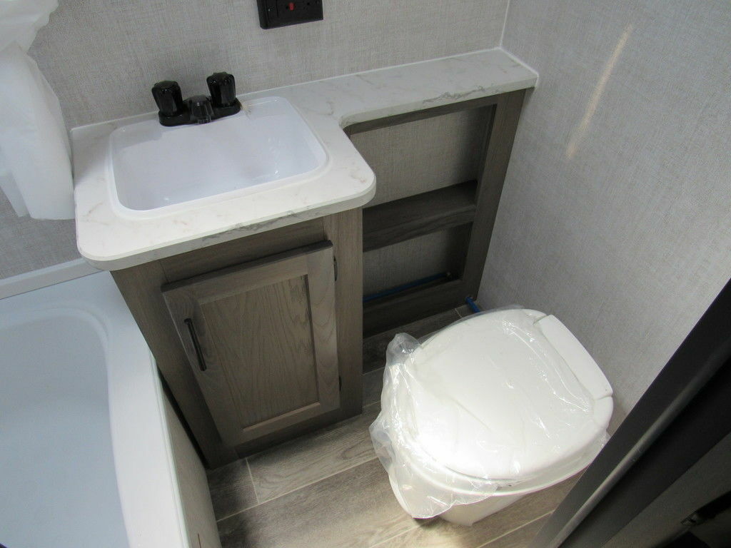 Bathroom with a sink, toilet and a shower.