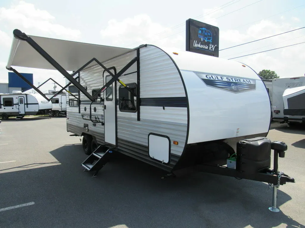 Front view of the RV with an awning.