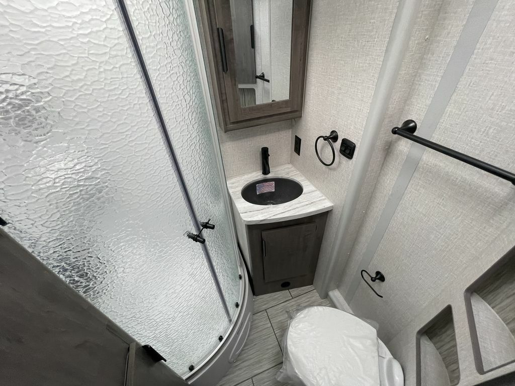 Bathroom with a sink, toilet and a walk-in shower.