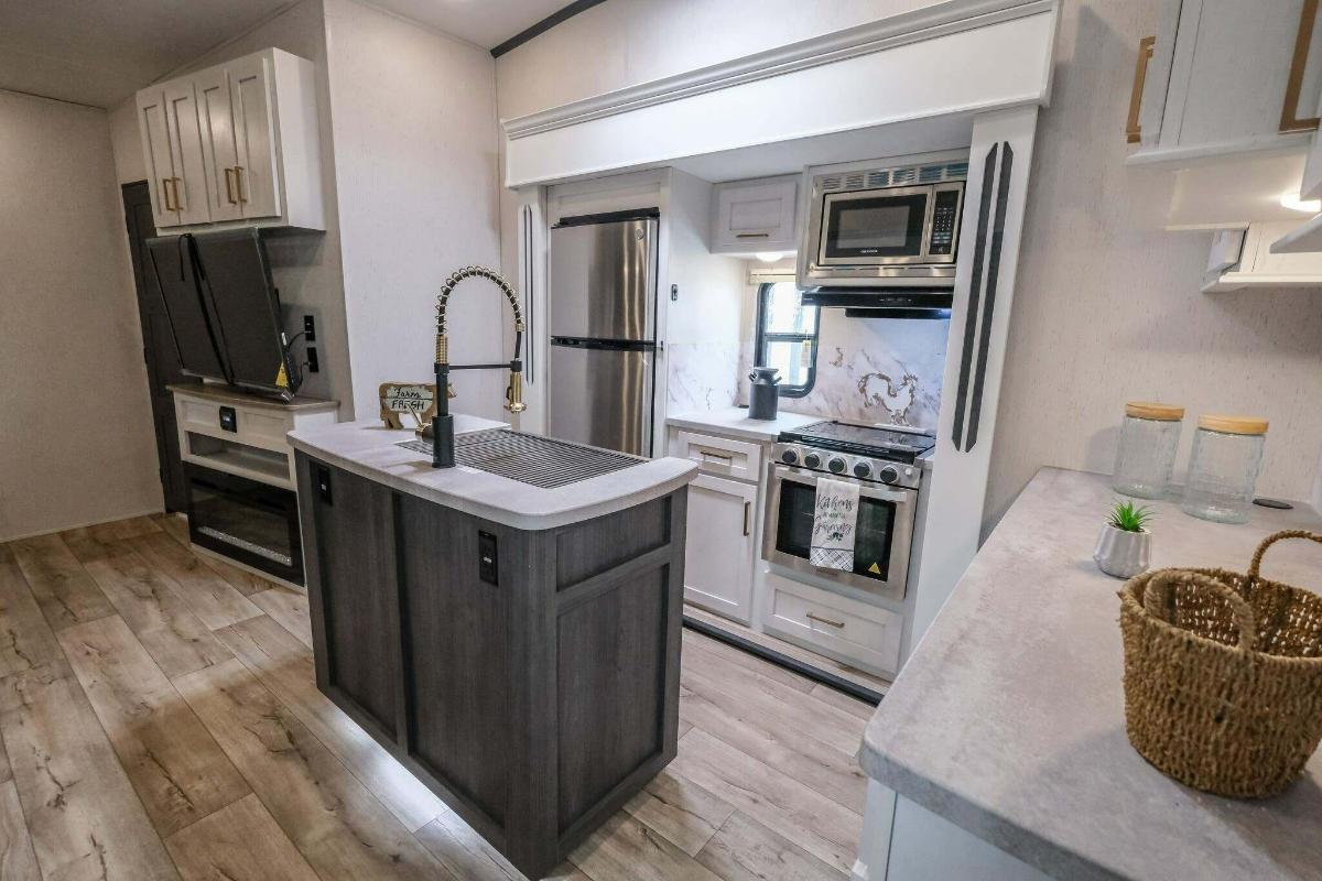 Kitchen with a gas burner, fridge, oven, sink and cabinets.