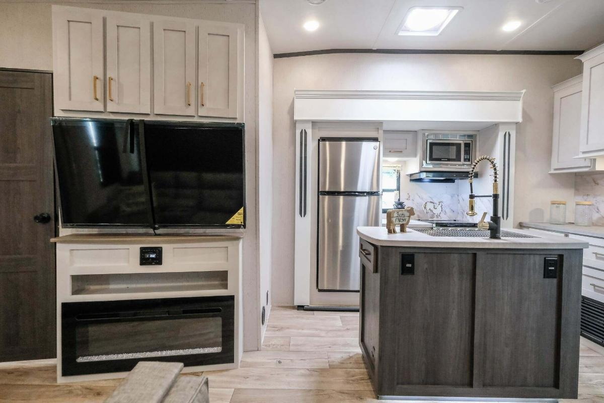 Entertainment center with a TV and a fireplace.