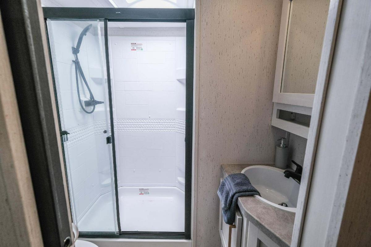 Bathroom with a sink, toilet and a walk-in shower.