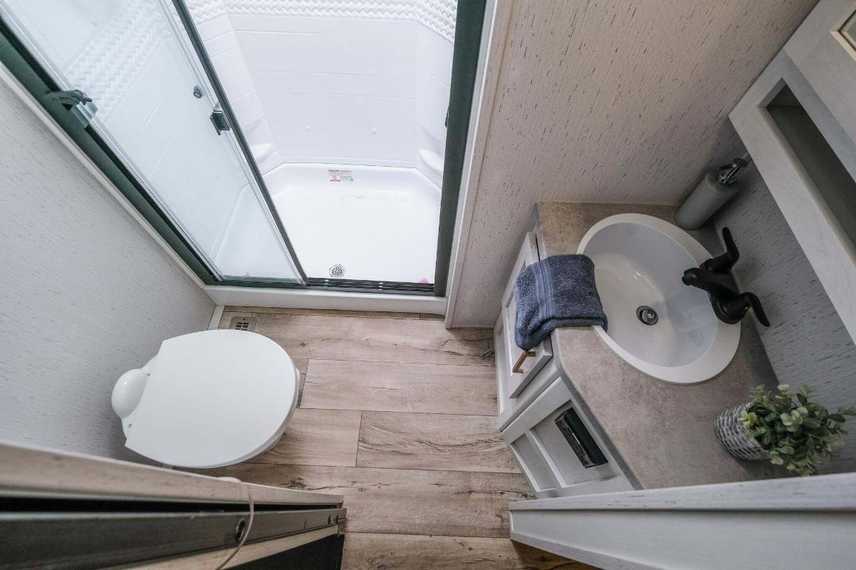 Bathroom with a sink, toilet and a walk-in shower.