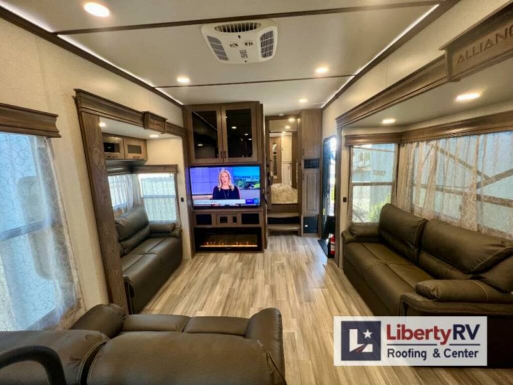 Living area with sofas, fireplace and a TV.