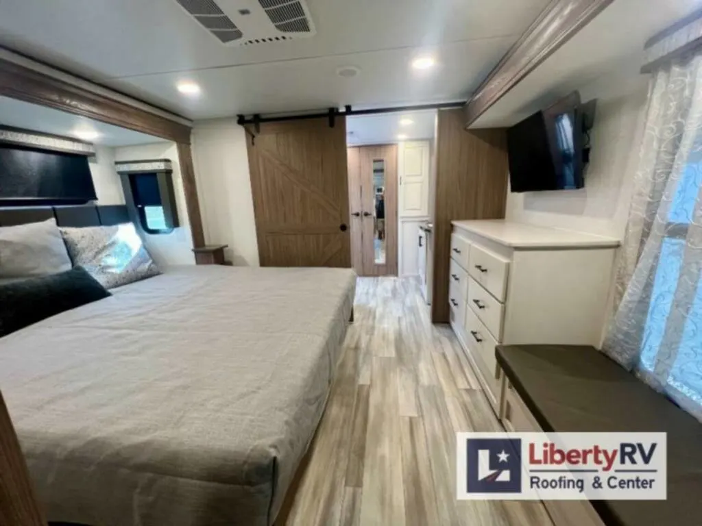 Bedroom with a king size bed and drawers.