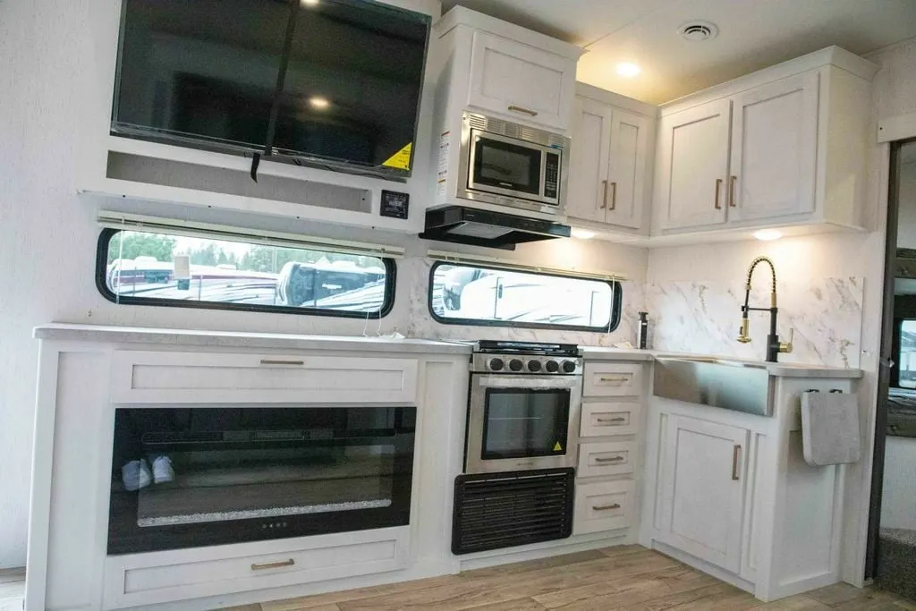 Kitchen with a gas burner, fridge, oven, sink and cabinets.