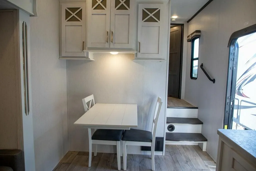 Dinette with overhead cabinets.