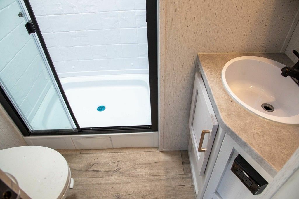 Bathroom with a sink, toilet and a walk-in shower.