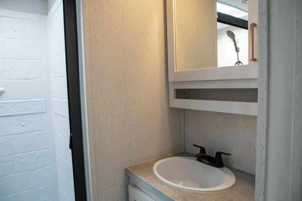 Bathroom with a sink and a walk-in shower.