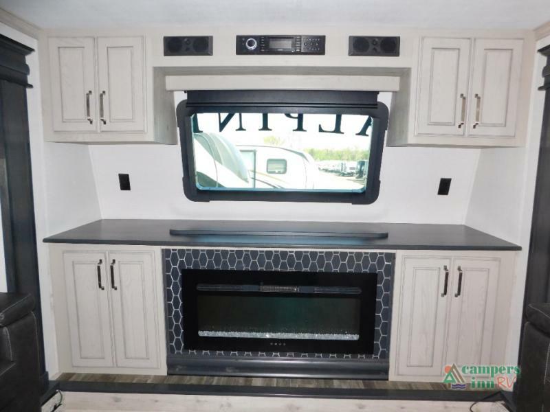 Entertainment center with a fireplace and cabinets.