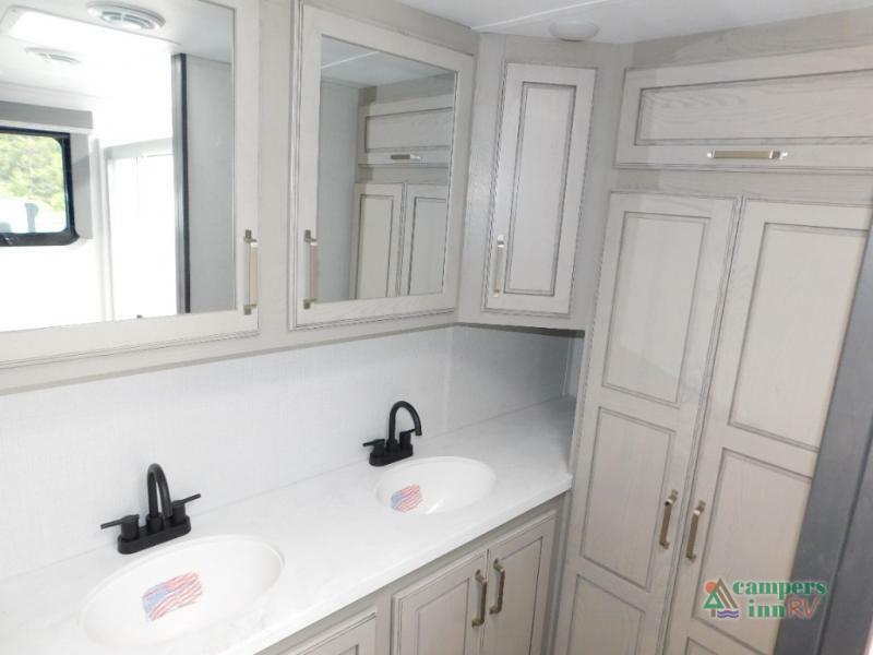 Bathroom with sinks, mirrors and cabinets.