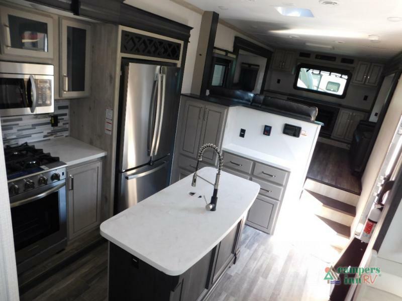 Kitchen with a gas burner, fridge, oven, sink and cabinets.