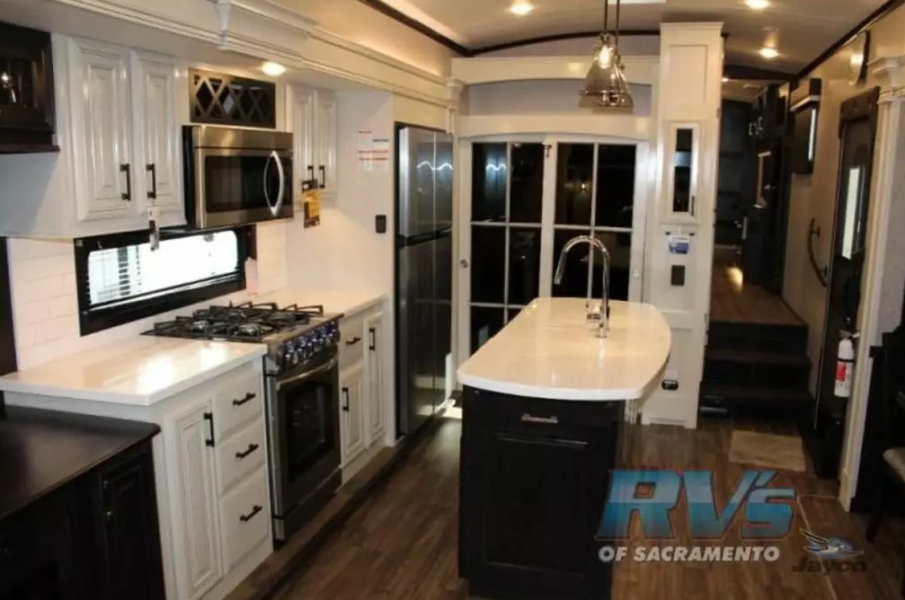 Kitchen with a gas burner, fridge, oven, sink and cabinets.