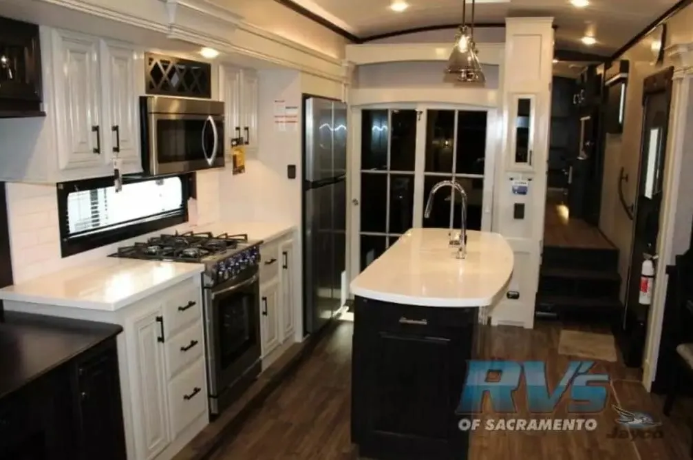 Kitchen with a gas burner, fridge, oven, sink and cabinets.