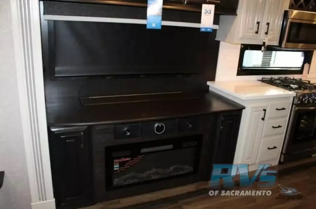 Entertainment center with a fireplace.