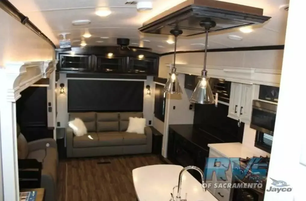 Interior view of the RV with a living space and a kitchen.