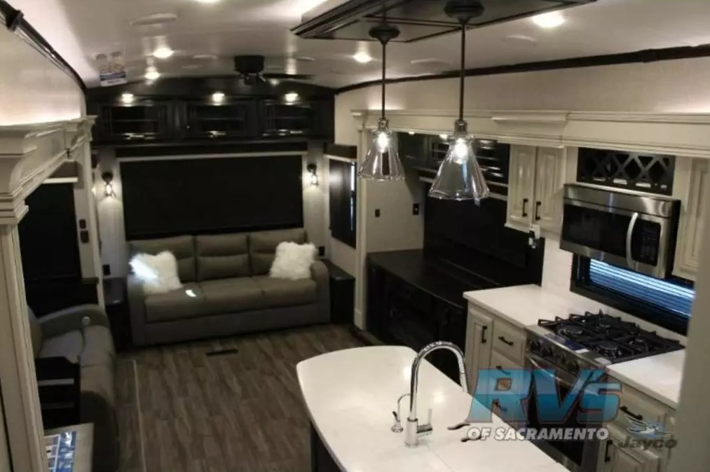 Interior view of the RV with a living space and a kitchen.