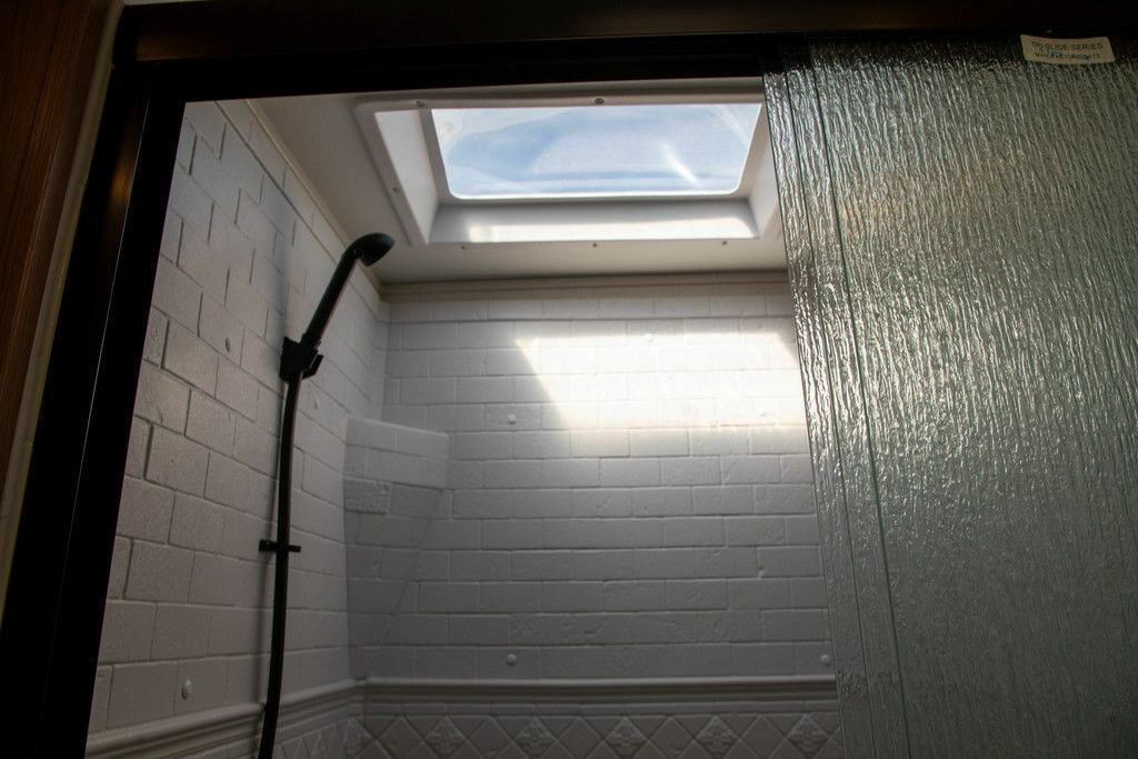 Walk-in shower with skylight.