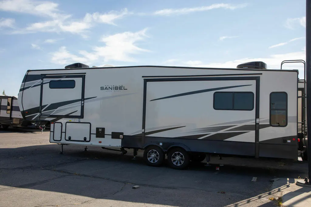 Side view of the New 2022 Prime Time Sanibel 3102WB Fifth Wheel RV.