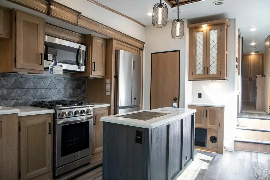 Kitchen with a gas burner, fridge, oven, sink and cabinets.