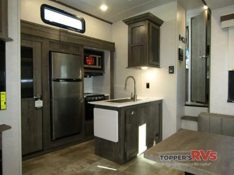 Kitchen with a gas burner, fridge, oven, sink and cabinets.