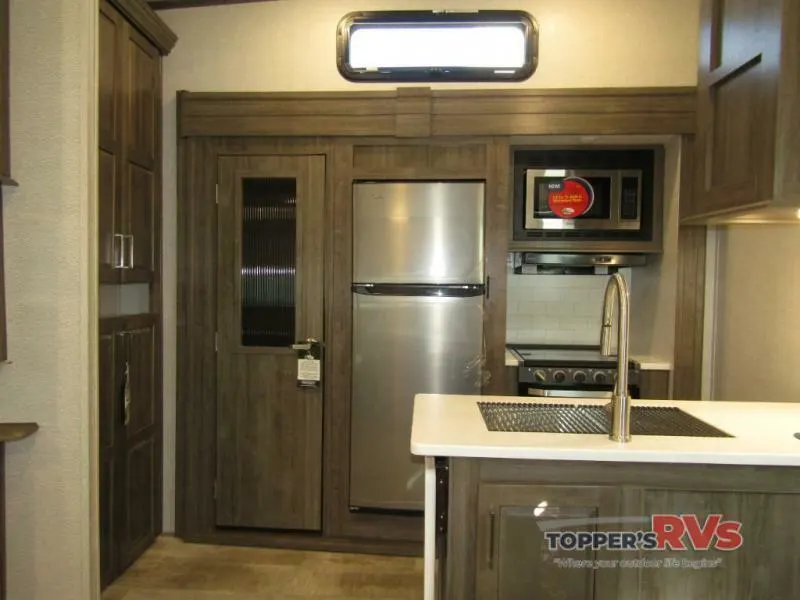 Kitchen with a gas burner, fridge, oven, sink and cabinets.