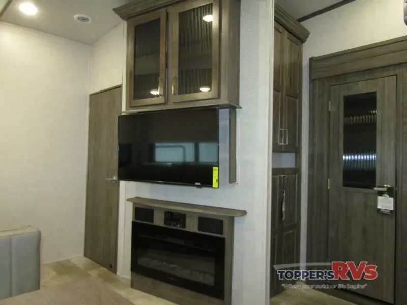 Entertainment center with a TV and a fireplace.