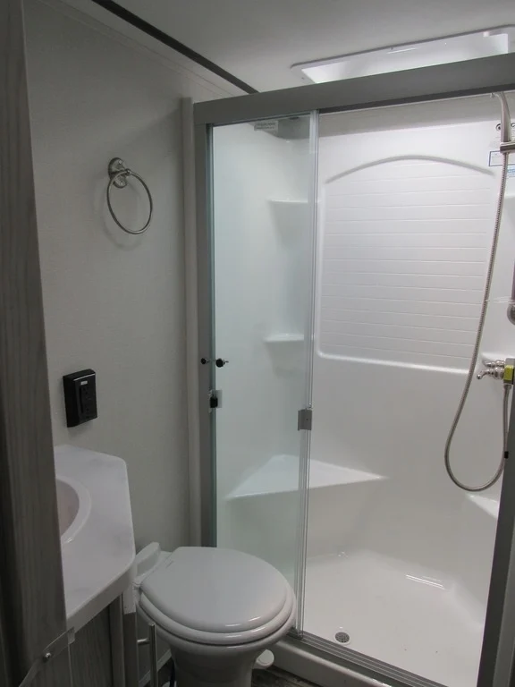 Bathroom with a sink, toilet and a walk-in shower.