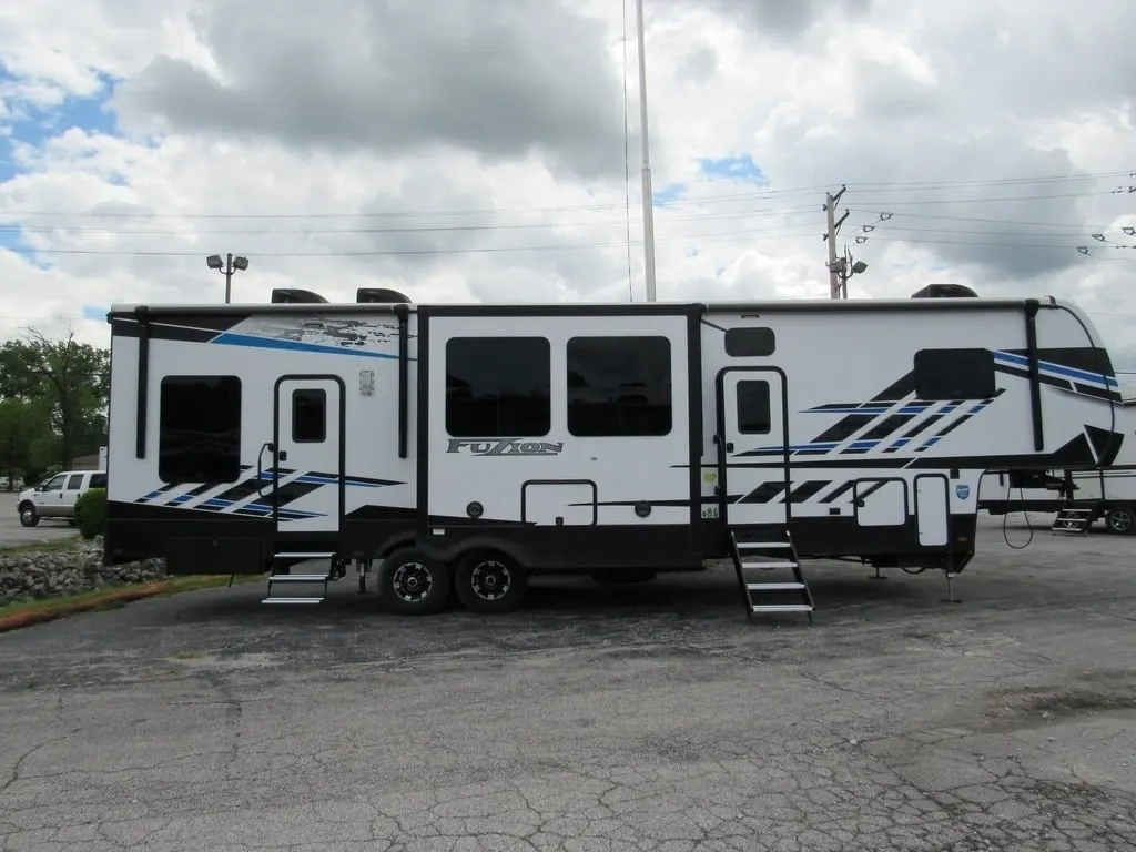 Side view of the New 2022 Keystone Fuzion 373 Fifth Wheel Toy Hauler RV.