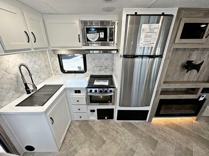 Kitchen with a gas burner, fridge, oven, sink and cabinets.