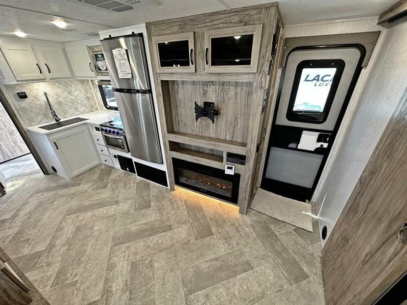 Kitchen with a gas burner, fridge, oven, sink and cabinets.