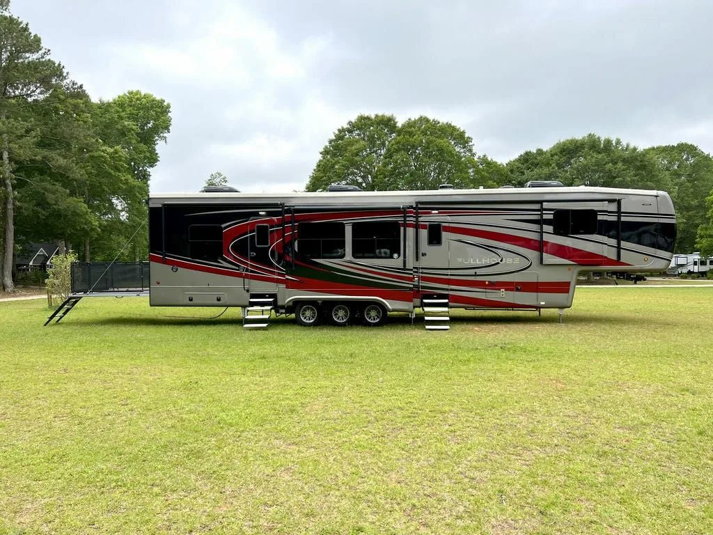 Side view of the New 2022 DRV Fifth Wheel Fullhouse Full House Luxury LX455 Toy Hauler RV.