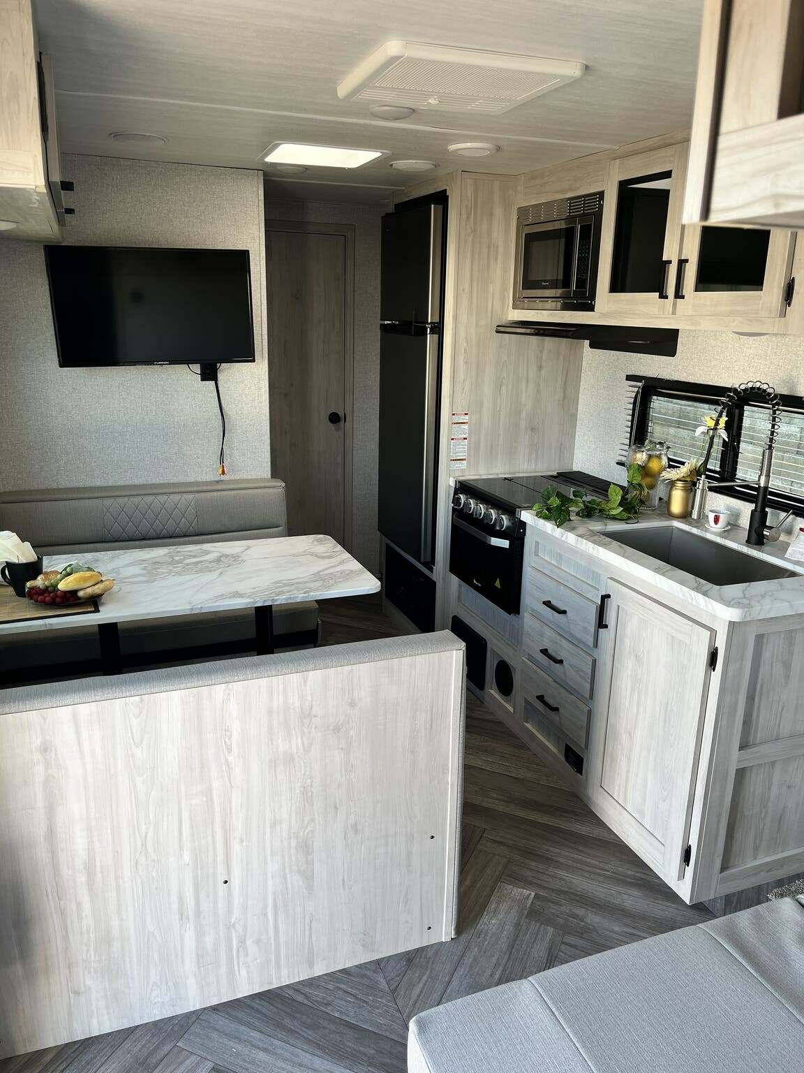 Interior view of the RV with a dinette and a kitchen.