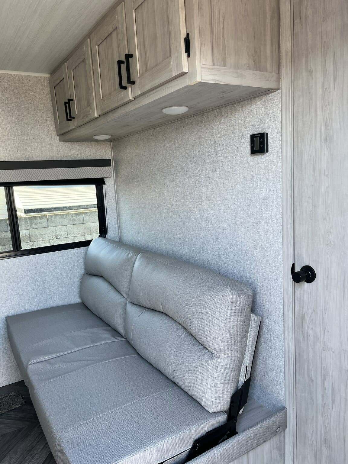 Living space with overhead cabinets.