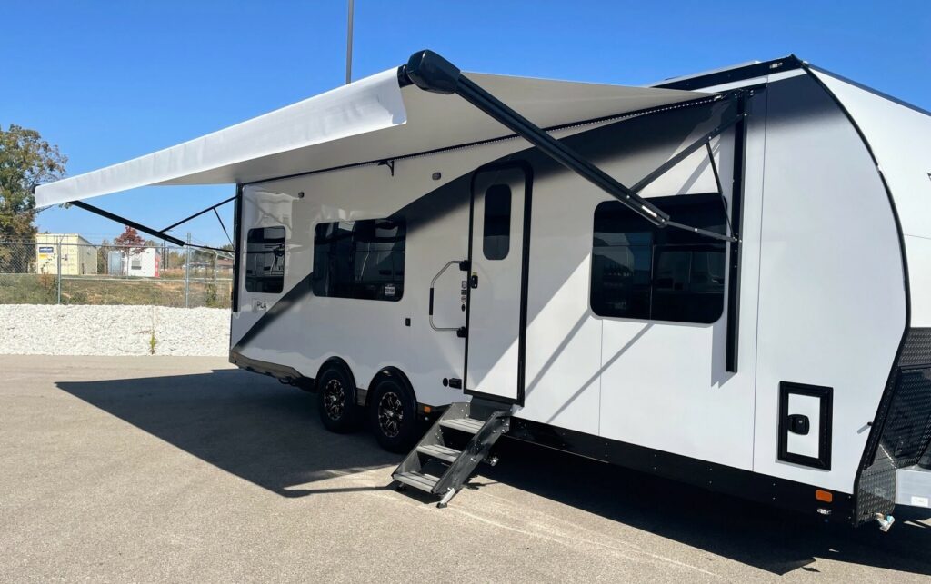 Side view of the RV with a camping tent.