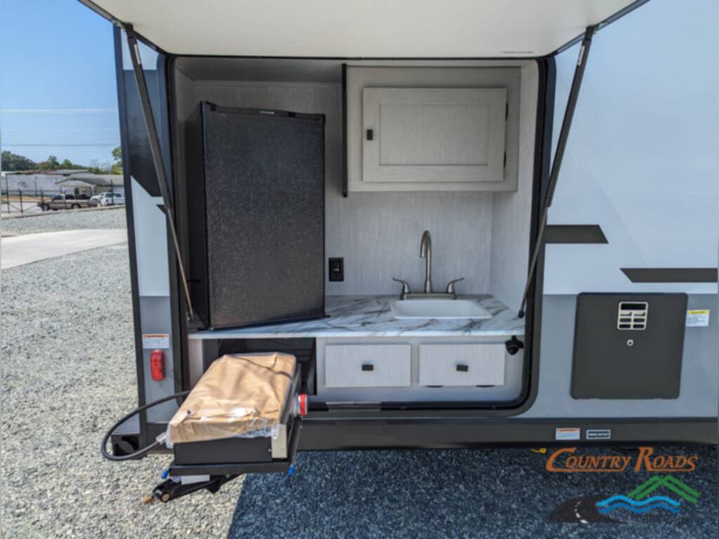 Exterior kitchen with a sink and a gas burner.