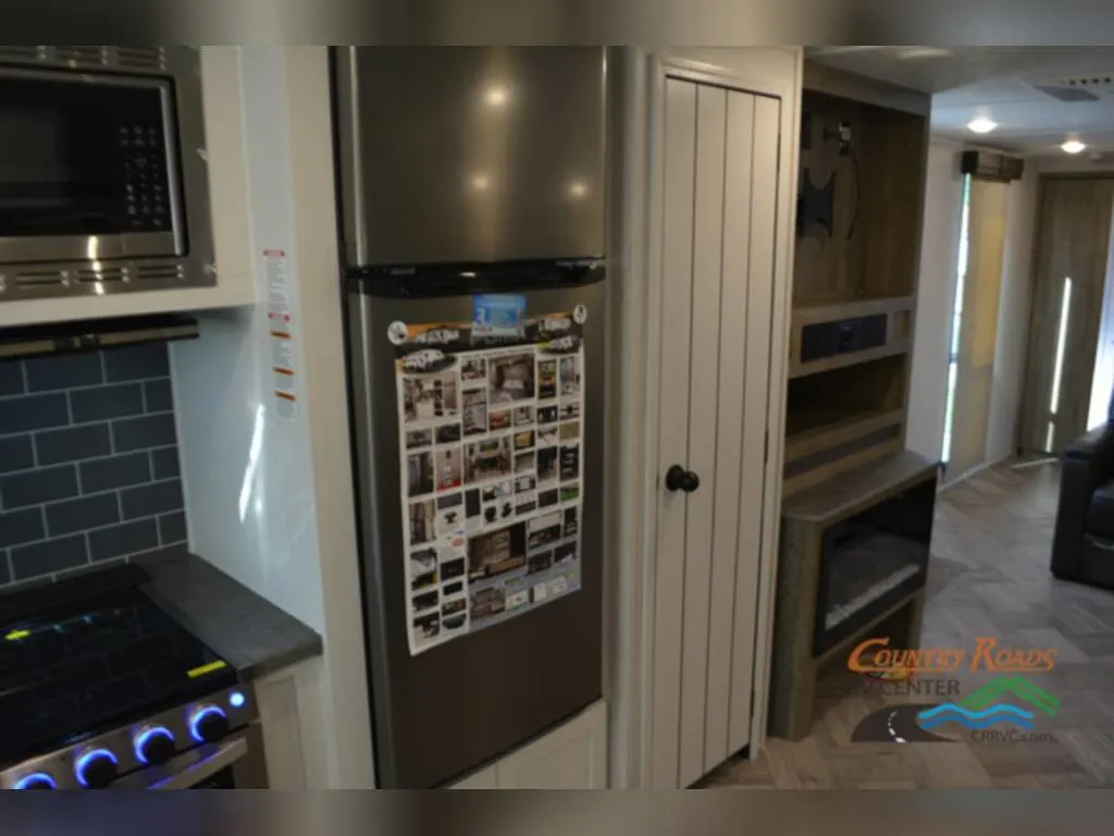 Kitchen with a fridge, cabinet and gas burner.