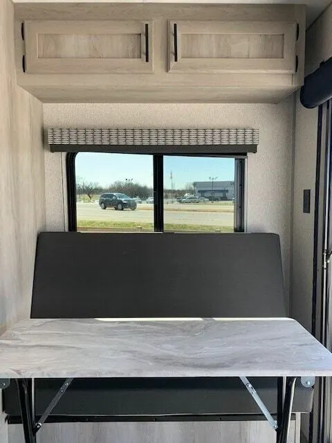 Dinette with overhead cabinets.