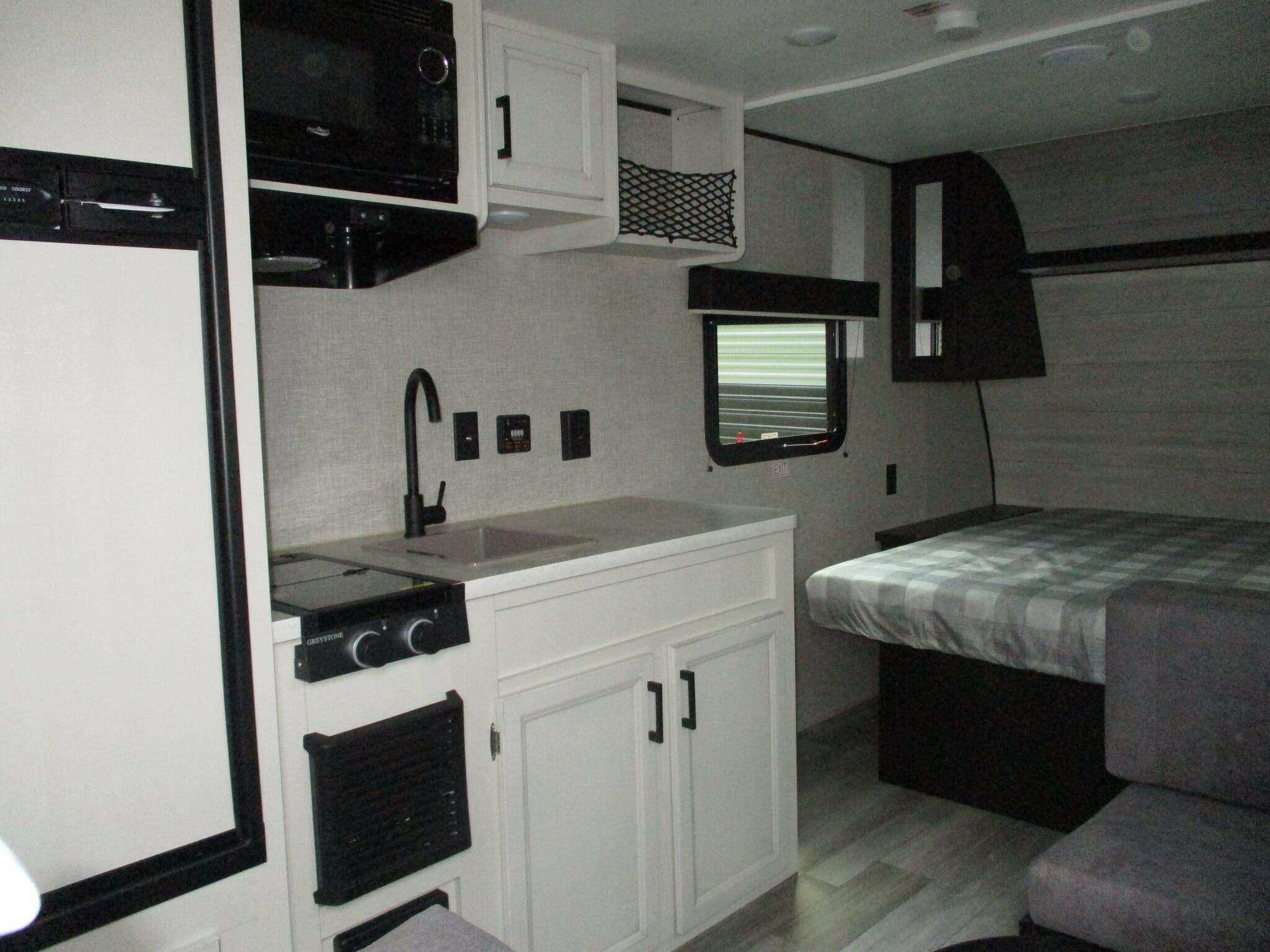 Kitchen with a gas burner, fridge, oven, sink and cabinets.