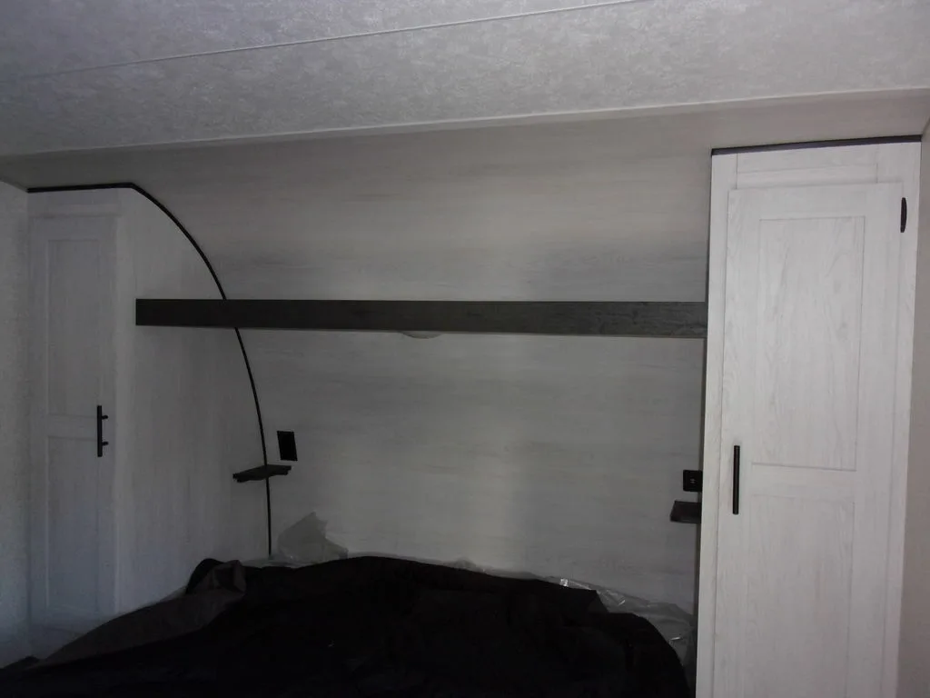 Bedroom with a queen size bed and shirt closets.