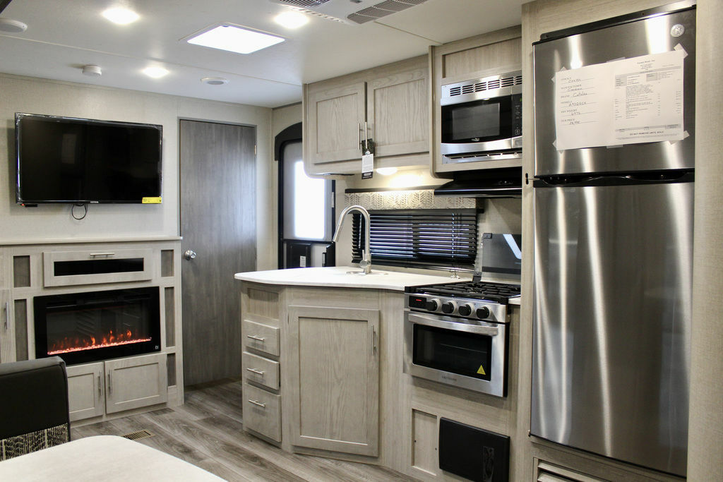 Kitchen with a gas burner, fridge, oven, sink and cabinets.