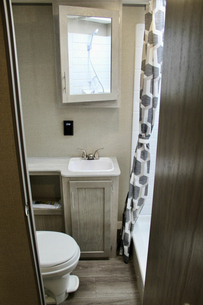 Bathroom with a sink, toilet, shower and a medicine cabinet.