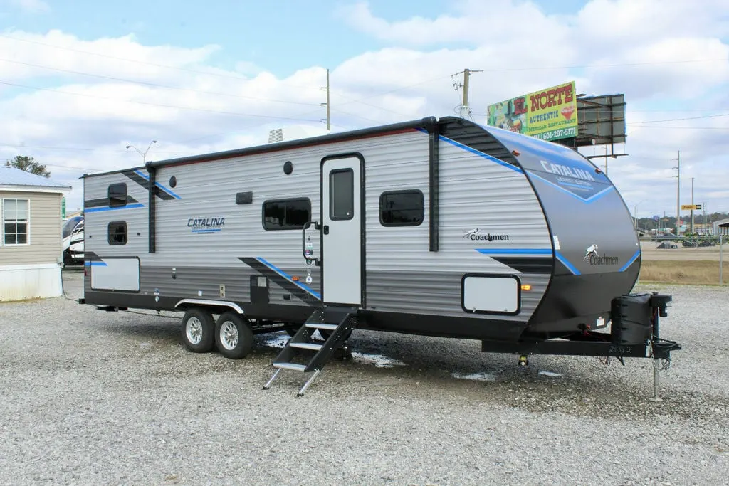 Side view of the New 2022 Coachmen Catalina Legacy Edition 293QBCK Travel Trailer RV.