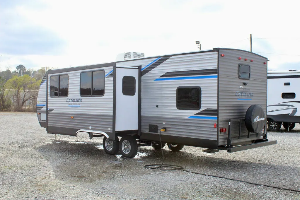 Side view of the New 2022 Coachmen Catalina Legacy Edition 293QBCK Travel Trailer RV.