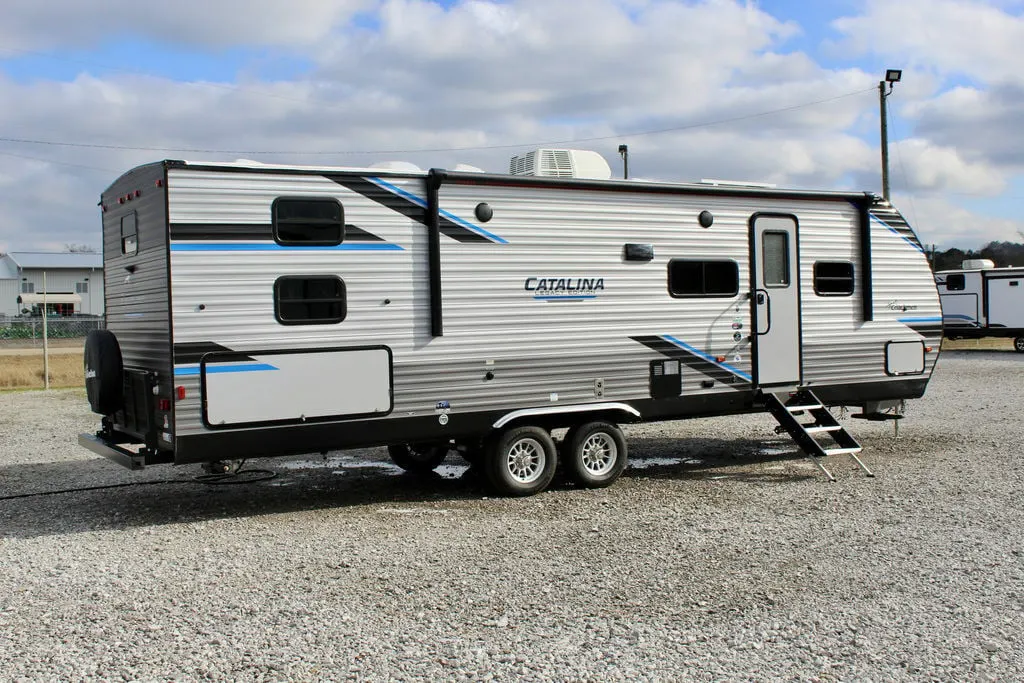 Side view of the New 2022 Coachmen Catalina Legacy Edition 293QBCK Travel Trailer RV.