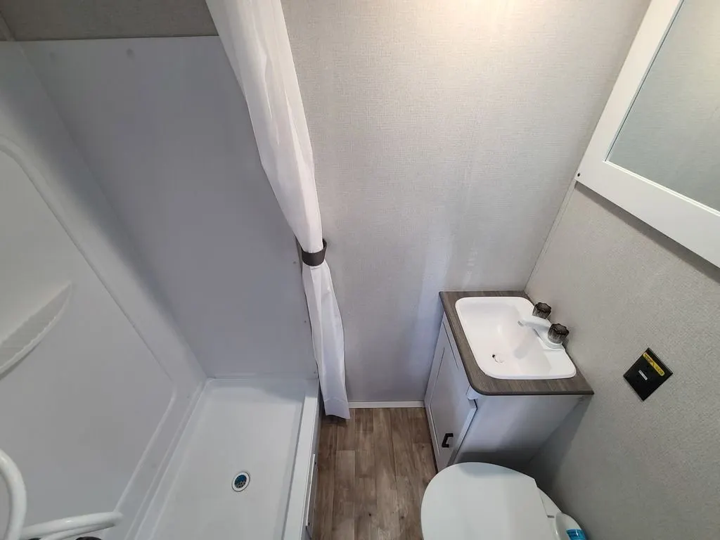 Bathroom with a sink, toilet and a shower.